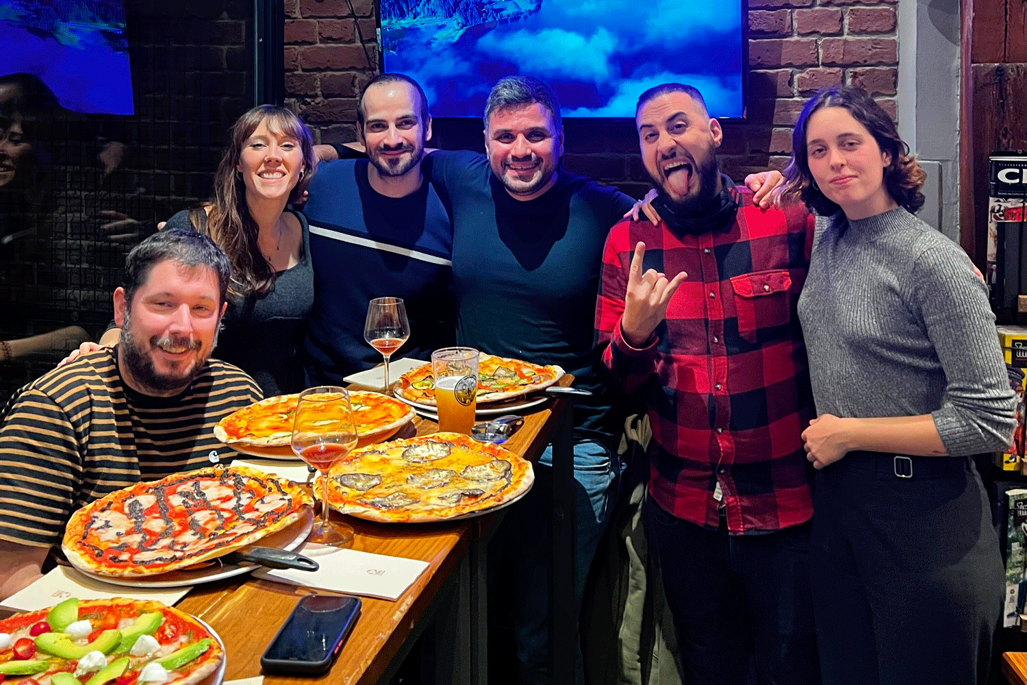 Stomio team having fun with pizza and beers